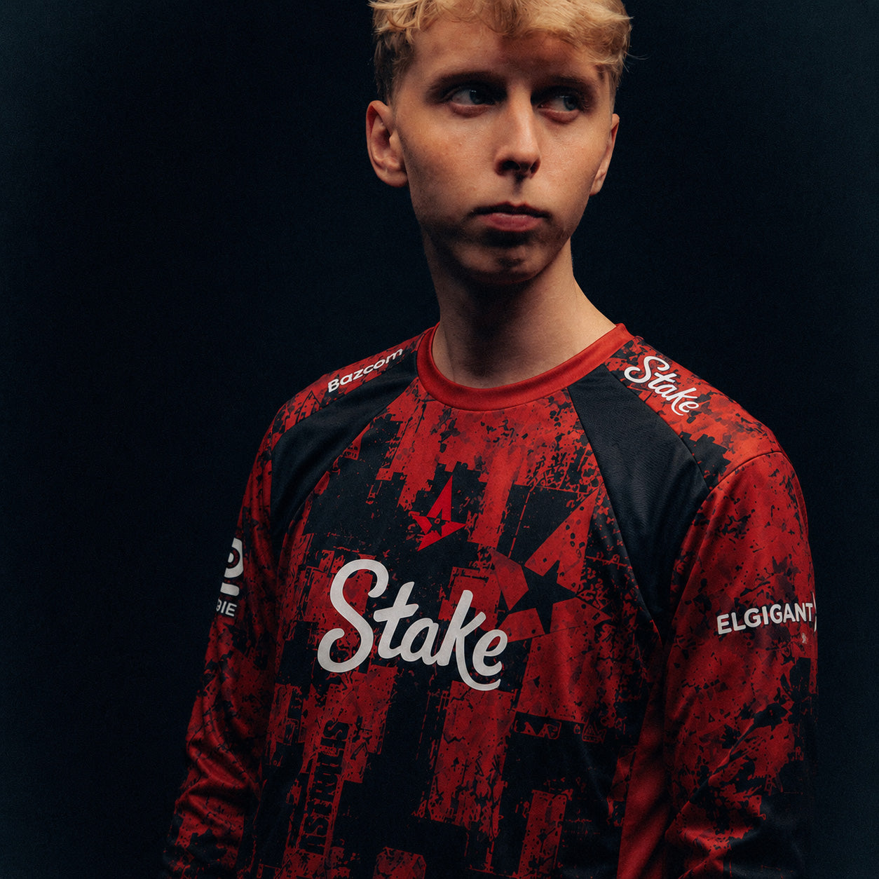 JABBI wearing a red and black Astralis jersey against a dark background