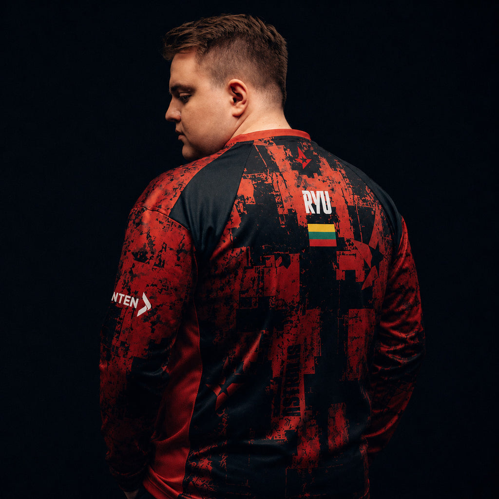 RYU wearing a red and black patterned Astralis jersey against a dark background