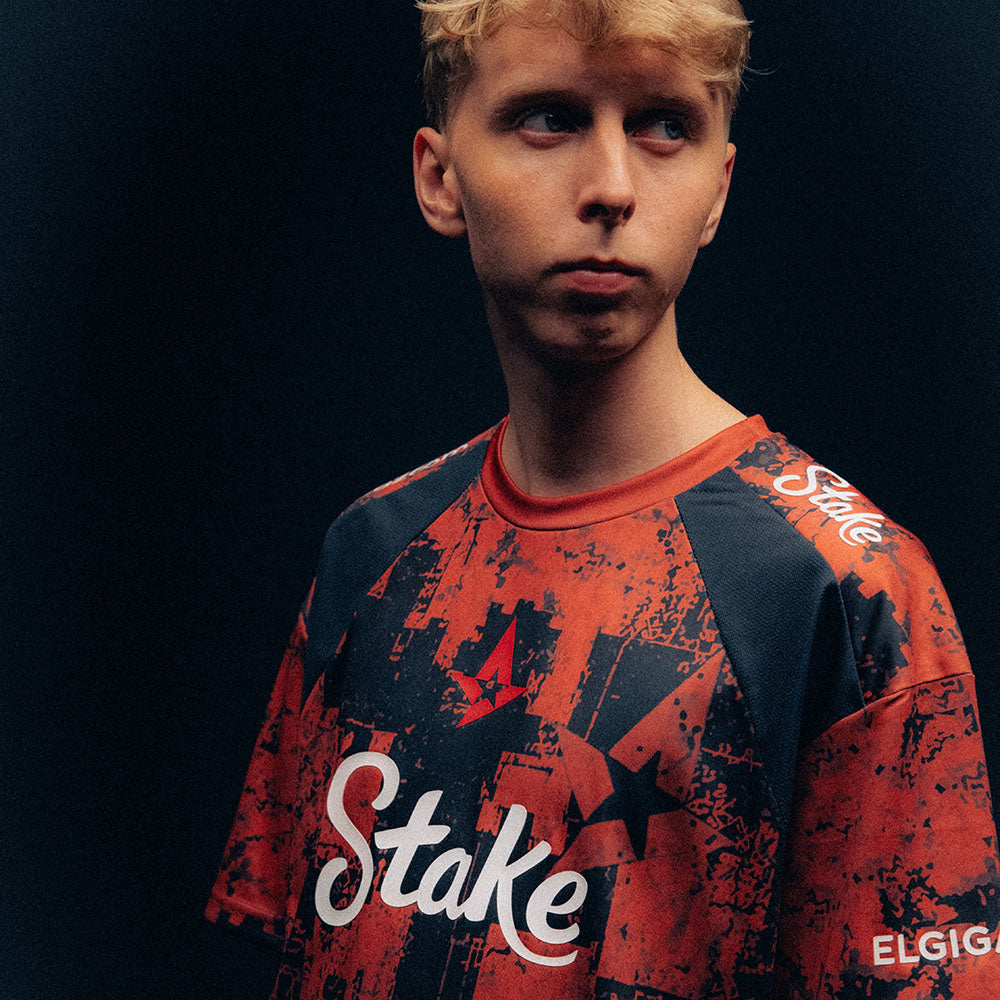 JABBI wearing a red and black Astralis jersey against a dark background